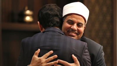 Prof Mohamed Hussein El Mahrassawy, President of Al Azhar University, right, hugs Judge Mohamed Abdel Salam, former advisor to the Grand Imam of Al Azhar, at a roundtable discussion in Abu Dhabi. AP Photo