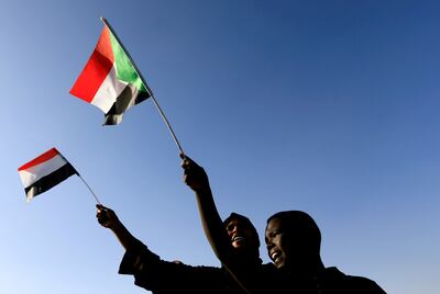 Sudanese wave their national flag as they gather at freedom square during the first anniversary of the start of the uprising that toppled long-time ruler Omar al-Bashir, in Khartoum, Sudan December 19, 2019. Reuters