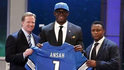 The Ghanian Ezekiel Ansah, centre, who began playing for Brigham Young University three years ago, stands alongside NFL commissioner Roger Goodell and Detroit Lions great Barry Sanders. Adam Hunger / Reuters