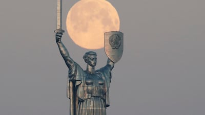 The pink supermoon sets behind the giant 'Mother of the Motherland' statue in central Kiev, Ukraine. Reuters