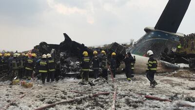 Wreckage of an airplane is pictured as rescue workers operate at Kathmandu airport, Nepal. Navesh Chitrakar / Reuters