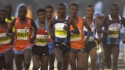 Dubai Marathon organisers are no longer pursuing high-profile runners such as Haile Gebrselassie, fourth from left, with large appearance fees. Jeff Topping / The National