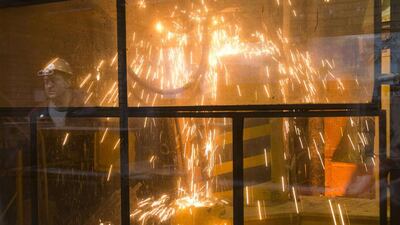 Metinvest stopped accepting new orders from buyers in May due to the crisis and halted its output at plants including Yenakiyieve Steel. Above, a steelworker operates machinery at the Ilich iron and steel plant in the southern coastal town of Mariupol. Vasily Fedosenko / Reuters