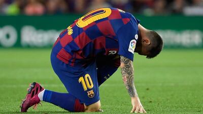 Barcelona's Argentine forward Lionel Messi reacts injured on the ground. AFP