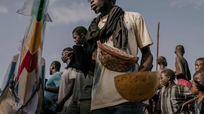 A man pours water from a calabash to honour the spirits and ensure protection at sea ahead of the pirogues race in Ngor, Senegal. AFP