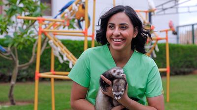 Afra Al Dhaheri holds two of her favourite animals: ferrets. She likes them because they are 'smart, sensitive, playful and loving'. Victor Besa / The National
