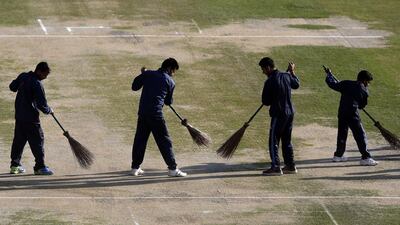 Indian workers prepare the pitch for the ICC World Twenty20 2016 cricket tournament at the Himachal Pradesh Cricket Association (HPCA) stadium in Dharmsala, India, Tuesday, March 8, 2016. The venue, which hosts several ICC Twenty20 World Cup matches, will hold the first match between Bangladesh and the Netherlands on March 9. (AP Photo /Tsering Topgyal)