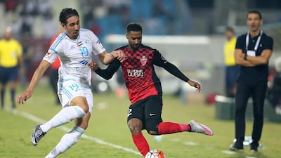 Abdulaziz Sanqour of Al Alhli, right, holds off Ishak Belfodil of Baniyas during the Arabian Gulf League match. Mostafa Reda / Al Ittihad