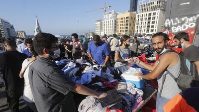 People collect donated items in Martyrs Square to help those affected by the prior days devastating explosion in Beirut. Getty Images