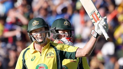 Australia's George Bailey (L) celebrates with team mate Steve Smith after making his century during the One Day International cricket match against India in Perth January 12, 2016. Bill Hatto / Reuters