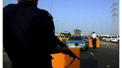 Some people say they cannot reach their jobs because of government checkpoints, such as this one in Riffa, where they fear being stopped, beaten or arrested.Hasan Jamali / AP Photo