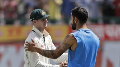Australia's captain Steven Smith, left, and India's captain Virat Kohli shake hands after their four-match Test series on Tuesday. Tsering Topgyal / AP Photo