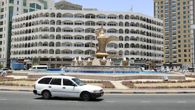 A roundabout in Fujairah with a giant dallah or Arab coffee pot surrounded by fountain 'coffee cups'.