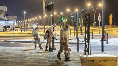 Sharjah municipal staff disinfect the streets of the emirate. Antonie Robertson / The National