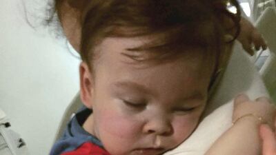 Alfie Evans cuddles his mother Kate James at Alder Hey Hospital, Liverpool, England.