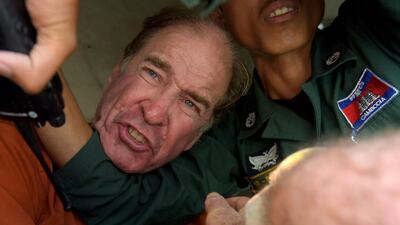 Australian filmmaker James Ricketson is driven away after being convicted of espionage in Phnom Penh on August 31, 2018. AFP