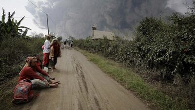 Residents rest after evacuating from villages engulfed by giant volcanic ash clouds from Mount Sinabung. Chaideer Mahyuddin / AFP Photo