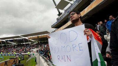 Such was the level of frustration, an India fan even displayed a sign against the rain. Jon Super / Ap Photo
