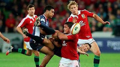 Rory Sidey of the Rebels is tackled by the Lions' Brad Barritt, centre, in Melbourne, Australia. David Rogers / Getty Images