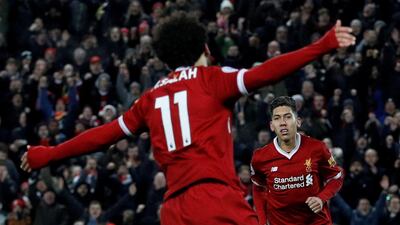 Liverpool's Roberto Firmino, right, celebrates scoring his side's fourth goal in a 5-0 win over Swansea City at Anfield. Phil Noble / Reuters