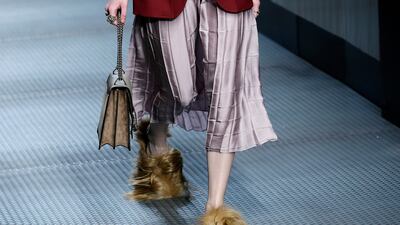 A model wears footwear with wisps of fur as part of the Gucci's autumn/winter 2015 collection. AP Photo