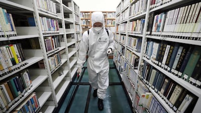 An army soldier sprays disinfectant to curb the spread of the coronavirus at a library in Daegu, South Korea. Yonhap via AP