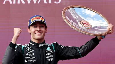 George Russell celebrates with the trophy on the podium after winning the Australian Grand Prix. Reuters