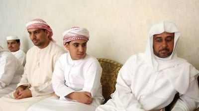 Ali Saeed Al Mehrzi, right, the father of Sabha Al Mehrzi, in the majlis at his villa in Wadi Al Ejeili with family and friends yesterday after the funeral of his daughter, who died after being struck by a lightning at the Fujairah Women’s College.