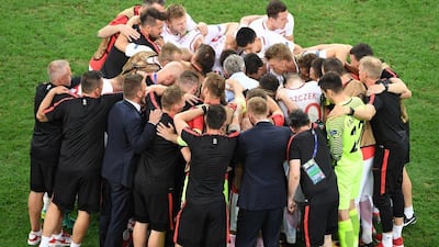 Poland players and staff in a huddle ahead of extra-time. Boris Horvat / AFP