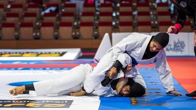 Alyaa Al Dhahnani overcame Reem Al Mansoori by submission to claim gold in the 63kg blue belt category. Victor Besa / The National