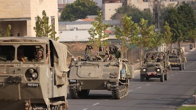 Israeli tanks and troops move through Sderot, near the border with Gaza, on Saturday. Getty Images
