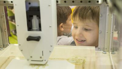 Children check out the Magic Candy Factory 3-D printer at Candylicious in Dubai Mall. (Antonie Robertson / The National)