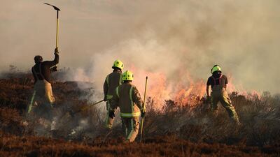 Firefighters tackle a blaze on moorland above Marsden. AFP