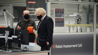 Boris Johnson talks with an employee at BAE Systems. AFP