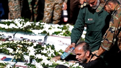 Father of four-year-old victim Mohammad Taha Eghdami, mourns over his body during a public funeral ceremony for those killed during an attack on a military parade on the weekend. AFP