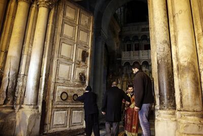 Christian clerics open the doors of the Church of the Holy Sepulchre, traditionally believed by many Christians to be the site of the crucifixion and burial of Jesus Christ, in Jerusalem. Mahmoud Illean/ AP Photo