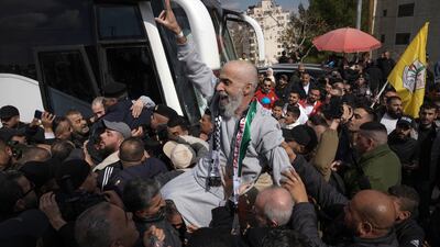 A freed Palestinian detainee is held aloft after arriving in Ramallah. AP