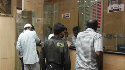 Currency appreciation back home is hitting Asian expatriates hard on their pockets. Above, a daily scene at a currency exchange in the UAE. Jeffrey E Biteng / The National