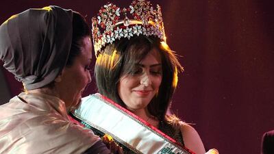 Abdulrahman from Kirkuk receives the Miss Iraq sash after winning the beauty contest. AFP