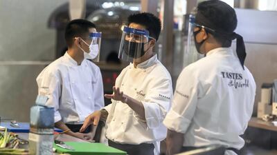 Chefs prepare food for attendees to try. Companies from about 85 countries are exhibiting their produce this week