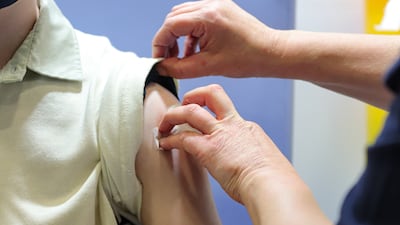 A child receives a first dose of the Covid-19 vaccine. PA
