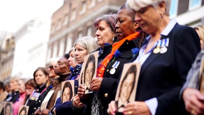 Former colleagues hold photos of Ms Fletcher. PA