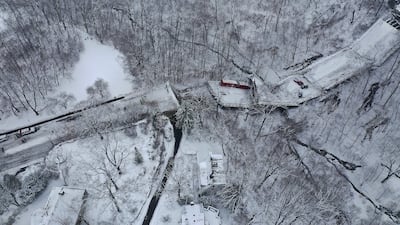 A Port Authority bus that was on a bridge when it collapsed on Friday is visible through trees in Pittsburgh's East End, in the US. AP