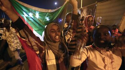 Sudanese protestors celebrate after an agreement was reached with the military council to form a three-year transition period for transferring power to a full civilian administration, in Khartoum, early on May 15, 2019. AFP