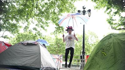 Royal superfan John Loughrey jumps for joy on The Mall, near Buckingham Palace, London, where he is already camped out for a prime position to view the platinum jubilee celebrations. PA