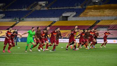 Roma players celebrate after beating Lazio. EPA