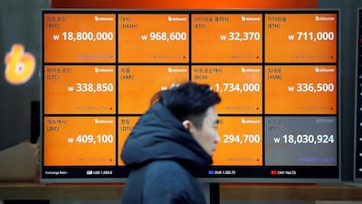 A man walks past an electric board showing exchange rates of various cryptocurrencies including Bitcoin at a cryptocurrencies exchange in Seoul, South Korea. Reuters