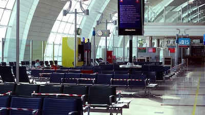 Passengers wait before boarding at Dubai International Airport on April 27, 2020. Reuters