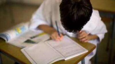 A boy writes during a class at Abu Dhabi's Mohamed bin Khaled School.