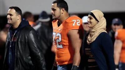 Former University of Virginia offensive tackle Oday Aboushi, centre, walks with his Palestinian parents during the Cavaliers’ final home game last season. Aboushi was drafted by the New York Jets in the fifth round and said he is proud to be one of a handful of Arab players in the NFL. Steve Helber / AP Photo